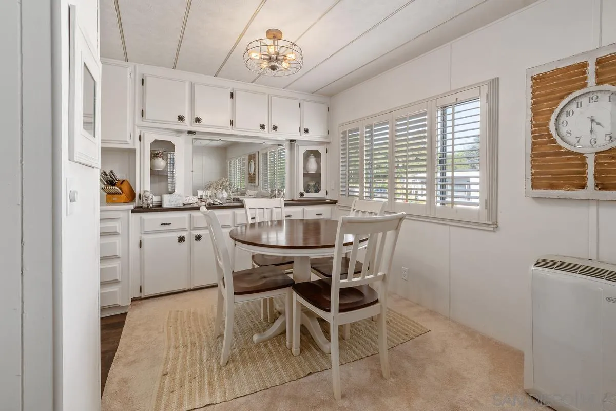 4747 Oak Crest Road, Unit 39 Fallbrook, CA 92028 - Photo 15 of 38 a kitchen with stainless steel appliances a table chairs refrigerator and cabinets