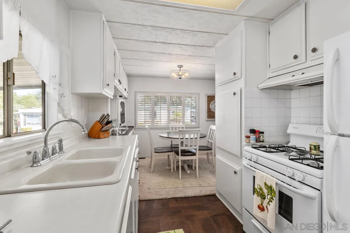 4747 Oak Crest Road, Unit 39 Fallbrook, CA 92028 - Photo 20 of 38 a kitchen with a white stove top oven and cabinets