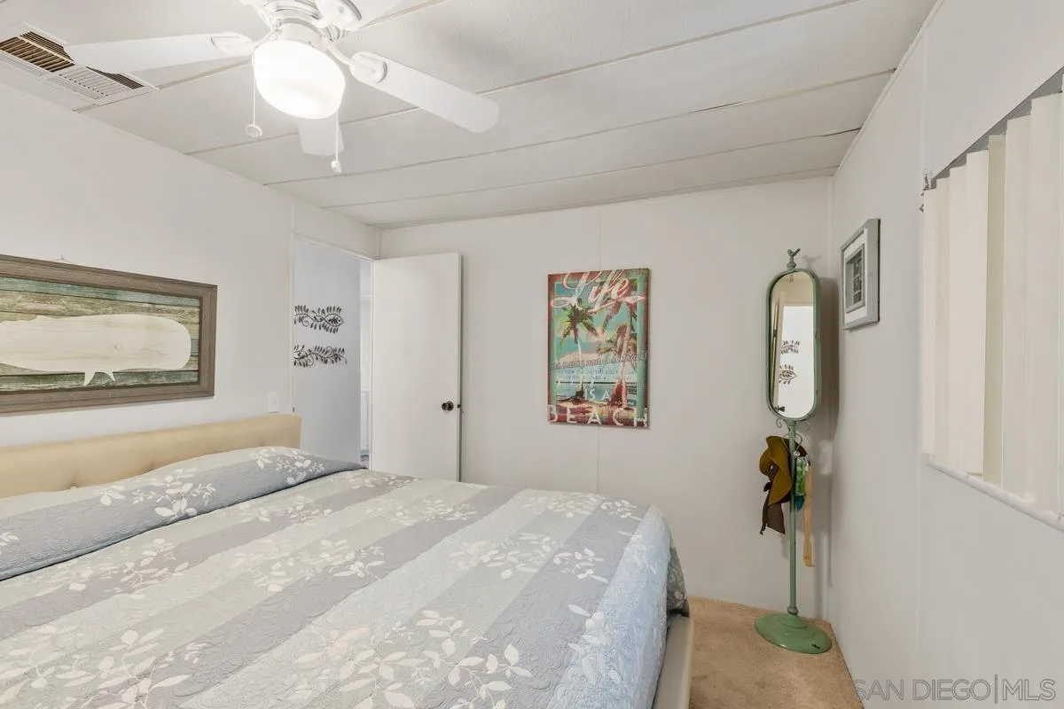 4747 Oak Crest Road, Unit 39 Fallbrook, CA 92028 - Photo 22 of 38 a bedroom with a bed and a chandelier