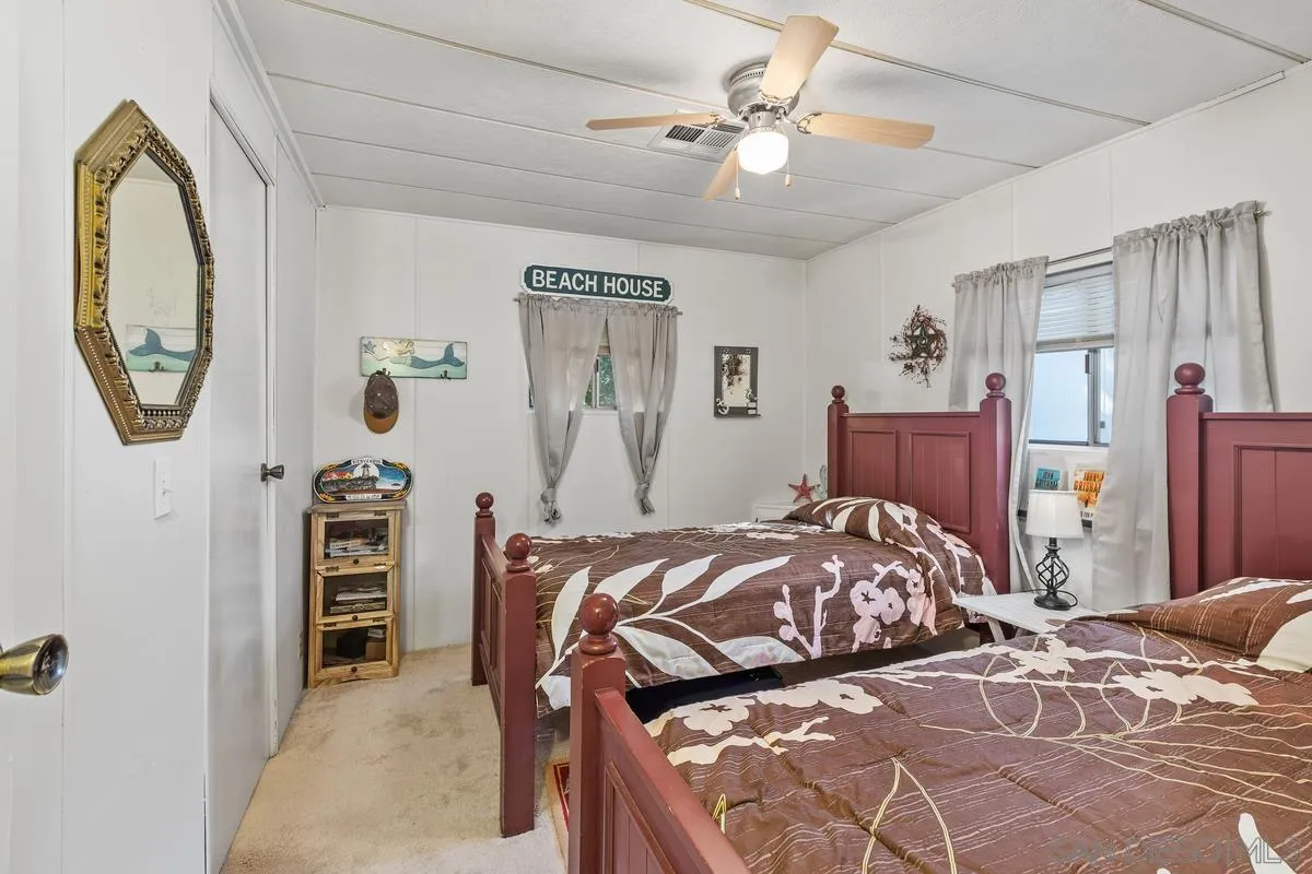 4747 Oak Crest Road, Unit 39 Fallbrook, CA 92028 - Photo 23 of 38 a bedroom with a bed and a chandelier