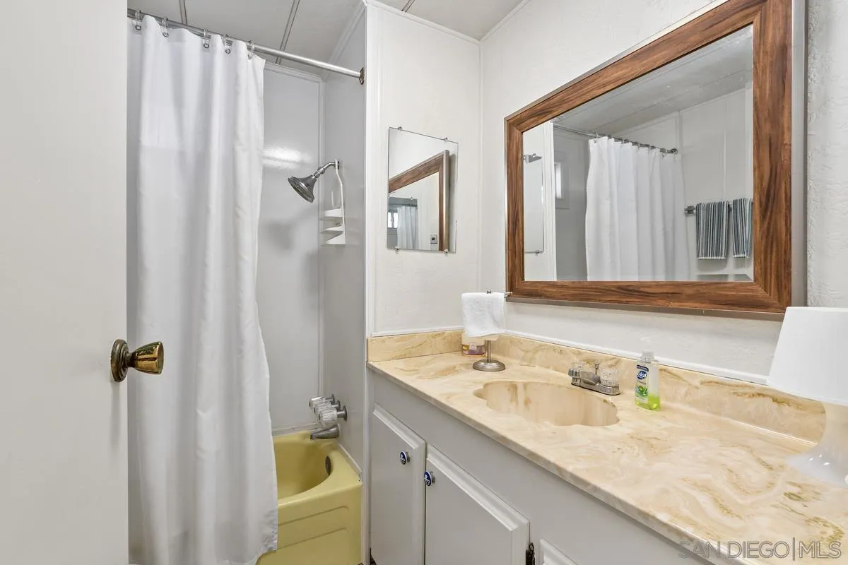4747 Oak Crest Road, Unit 39 Fallbrook, CA 92028 - Photo 25 of 38 a bathroom with a granite countertop sink and a mirror