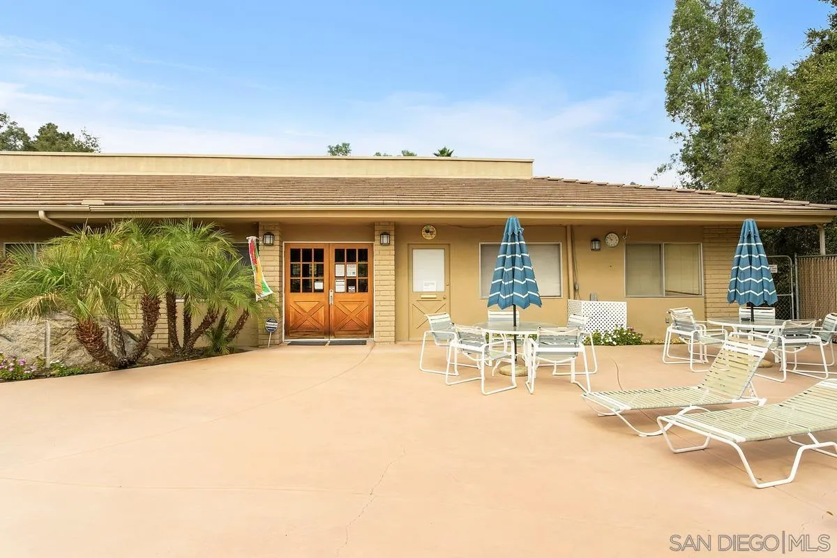 4747 Oak Crest Road, Unit 39 Fallbrook, CA 92028 - Photo 35 of 38 a view of a patio with table and chairs and potted plants with sky view