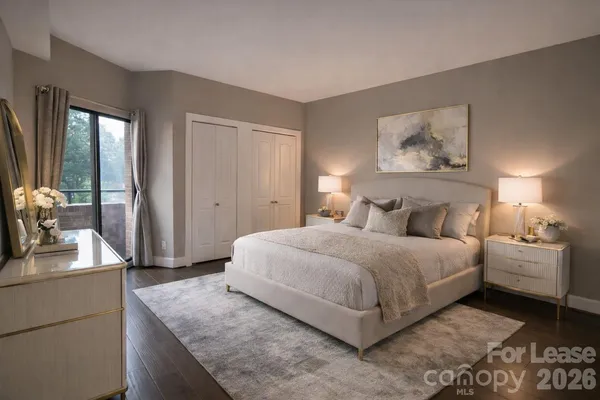 a bedroom with a bed and a dresser with mirror