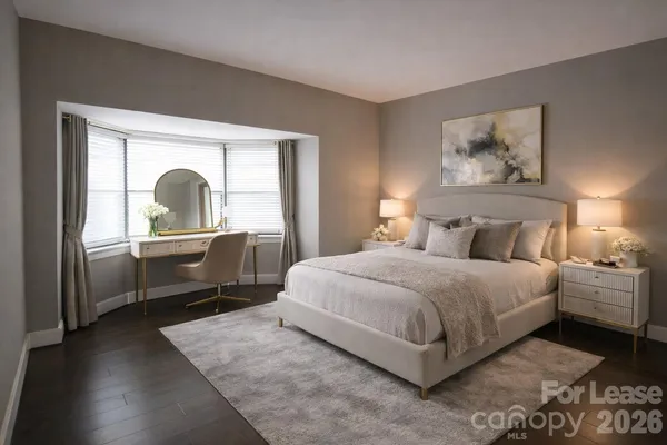 a bedroom with a bed and a large window