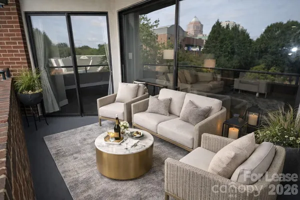 a living room with furniture and a potted plant