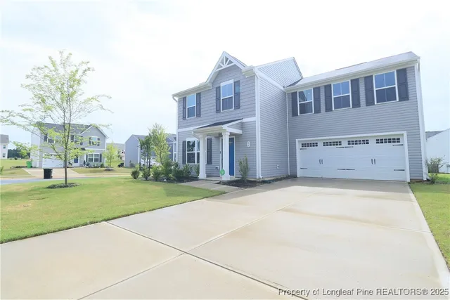 a front view of a house with a yard and garage
