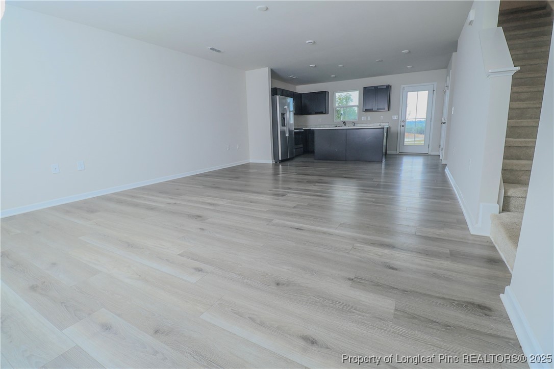 96 Cutty Way Lillington, NC 27546 - Photo 6 of 37 a view of kitchen and hall with wooden floor