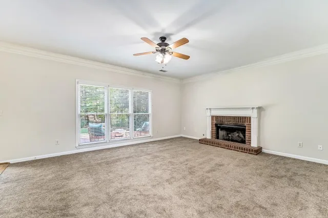 an empty room with fireplace and windows