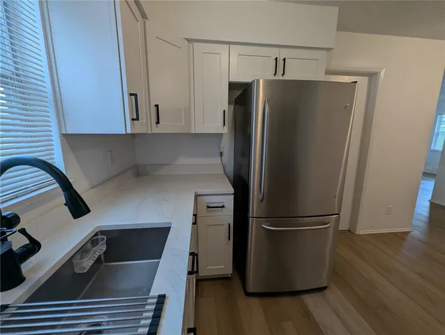 a kitchen with a refrigerator and a sink