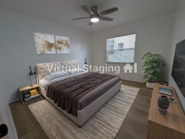 a bedroom with bed and wooden floor