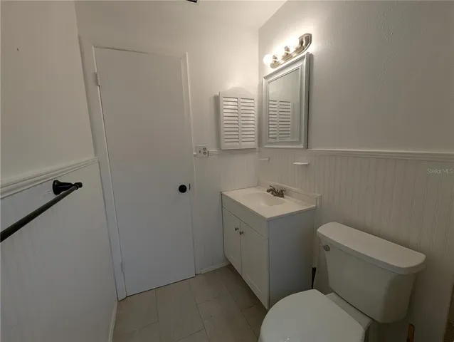 a bathroom with a sink a toilet and mirror