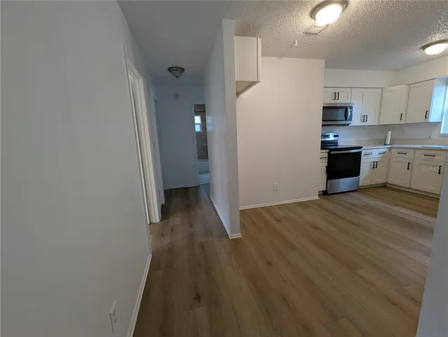 a kitchen with a refrigerator and a stove top oven