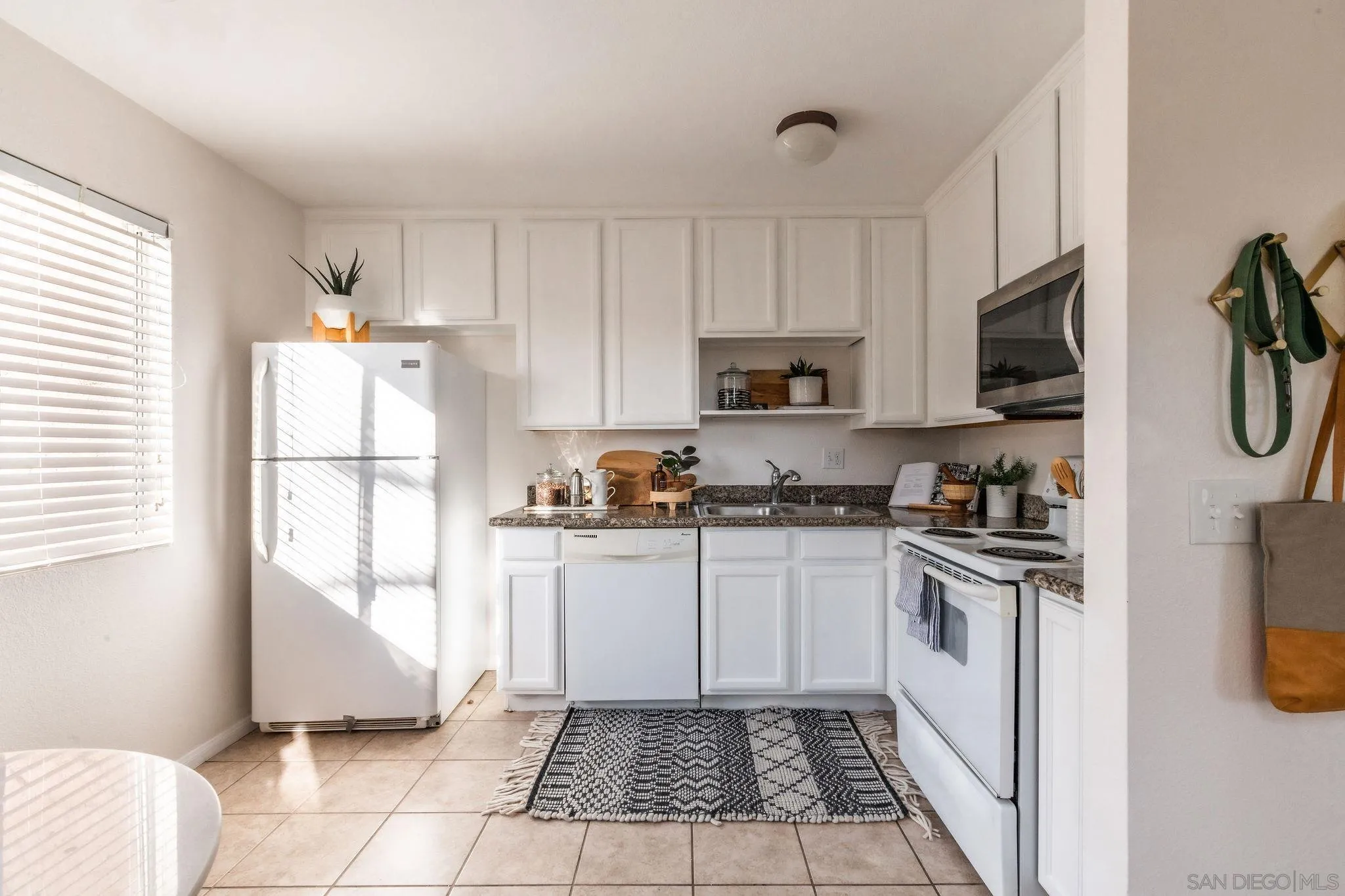10235 Madrid Way, Unit 138 Spring Valley, CA 91977 - Photo 11 of 21 a kitchen with stainless steel appliances granite countertop a refrigerator stove top oven and sink
