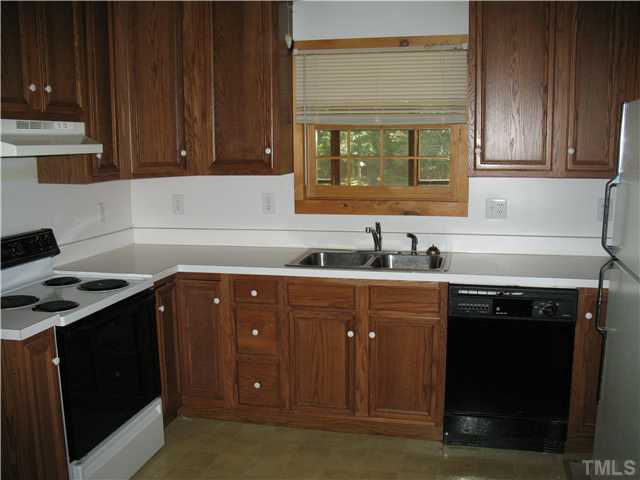 86 Log Home Road Timberlake, NC 27583 - Photo 5 of 12 a kitchen with stainless steel appliances granite countertop a stove a sink and a microwave