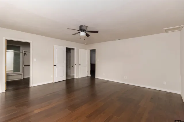 a view of an empty room with wooden floor