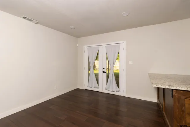 a view of room with wooden floor