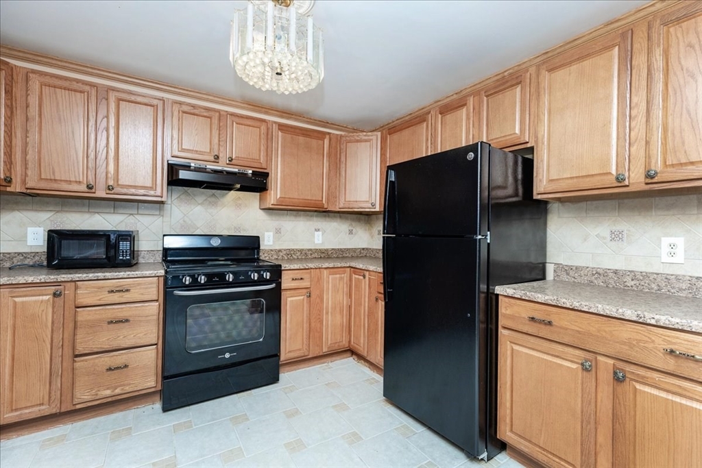176 Maple Avenue, Unit 138 Rutland, MA 01543 - Photo 11 of 29 a kitchen with stainless steel appliances granite countertop a refrigerator stove top oven a sink and dishwasher