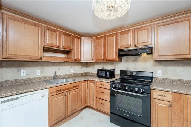 a kitchen with a stove a sink and a microwave