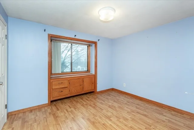 a view of a room with wooden floor and windows