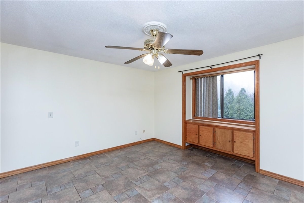 176 Maple Avenue, Unit 138 Rutland, MA 01543 - Photo 23 of 29 a view of a big room with chandelier fan and windows