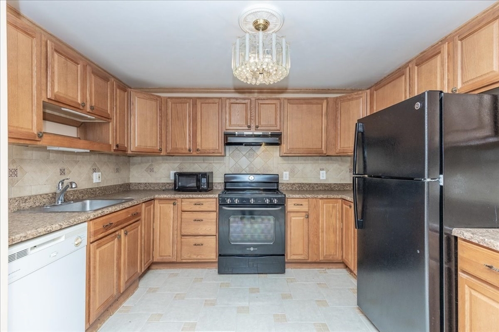 176 Maple Avenue, Unit 138 Rutland, MA 01543 - Photo 10 of 29 a kitchen with stainless steel appliances granite countertop a refrigerator sink and cabinets