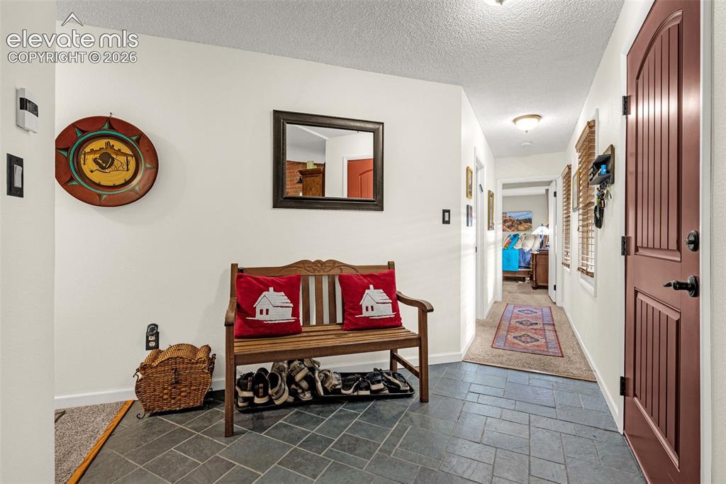 1658 Deer Creek Road Monument, CO 80132 - Photo 4 of 21 Welcoming entry foyer with tile flooring and double closet