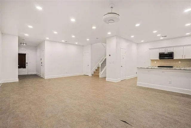 a view of kitchen with kitchen island a sink stainless steel appliances and cabinets