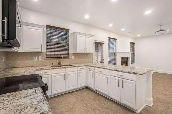 a kitchen with a sink stove and cabinets