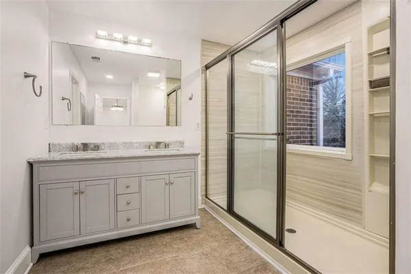 a bathroom with a granite countertop sink mirror and double