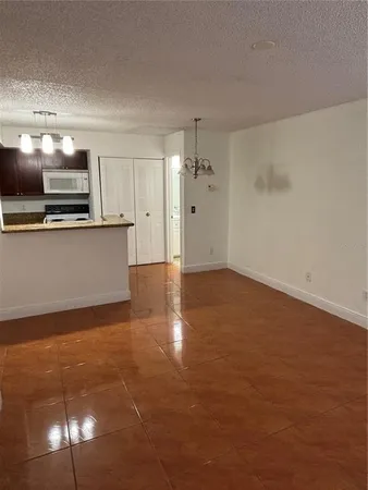 a view of kitchen with microwave and cabinets