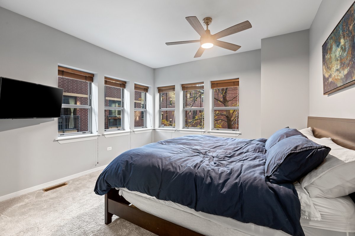 1159 North Hudson Avenue, Unit 6 Chicago, IL 60610 - Photo 13 of 24 a bed sitting in a bedroom next to a window