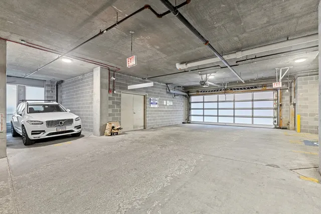a view of parking garage with a car parked