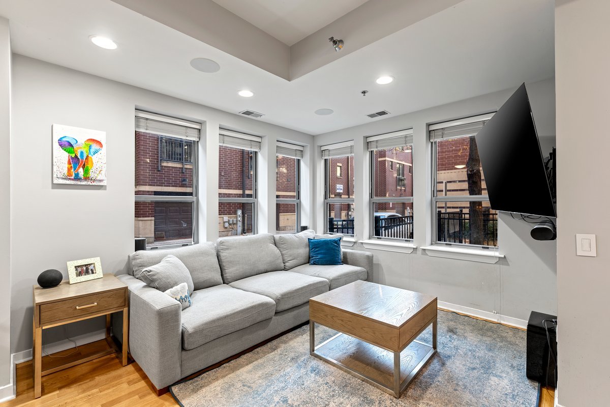 1159 North Hudson Avenue, Unit 6 Chicago, IL 60610 - Photo 2 of 24 a living room with furniture a flat screen tv and a window
