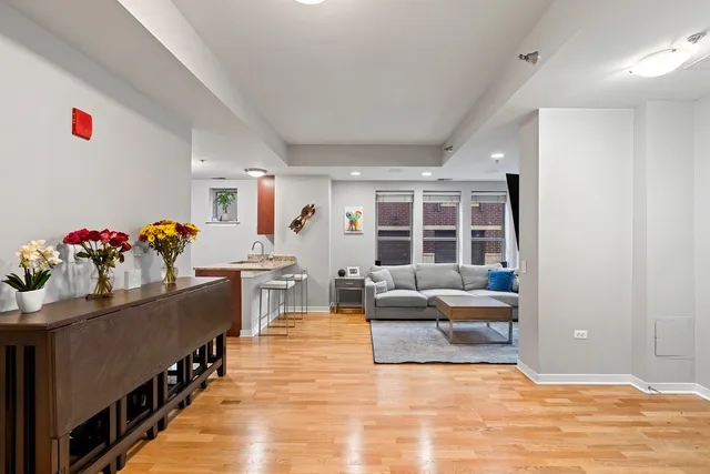 a living room with furniture and flowers