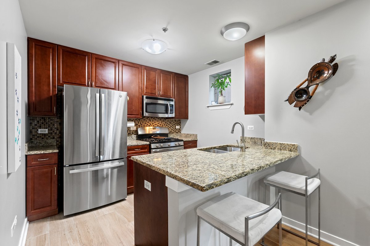 1159 North Hudson Avenue, Unit 6 Chicago, IL 60610 - Photo 6 of 24 a kitchen with a refrigerator and a sink