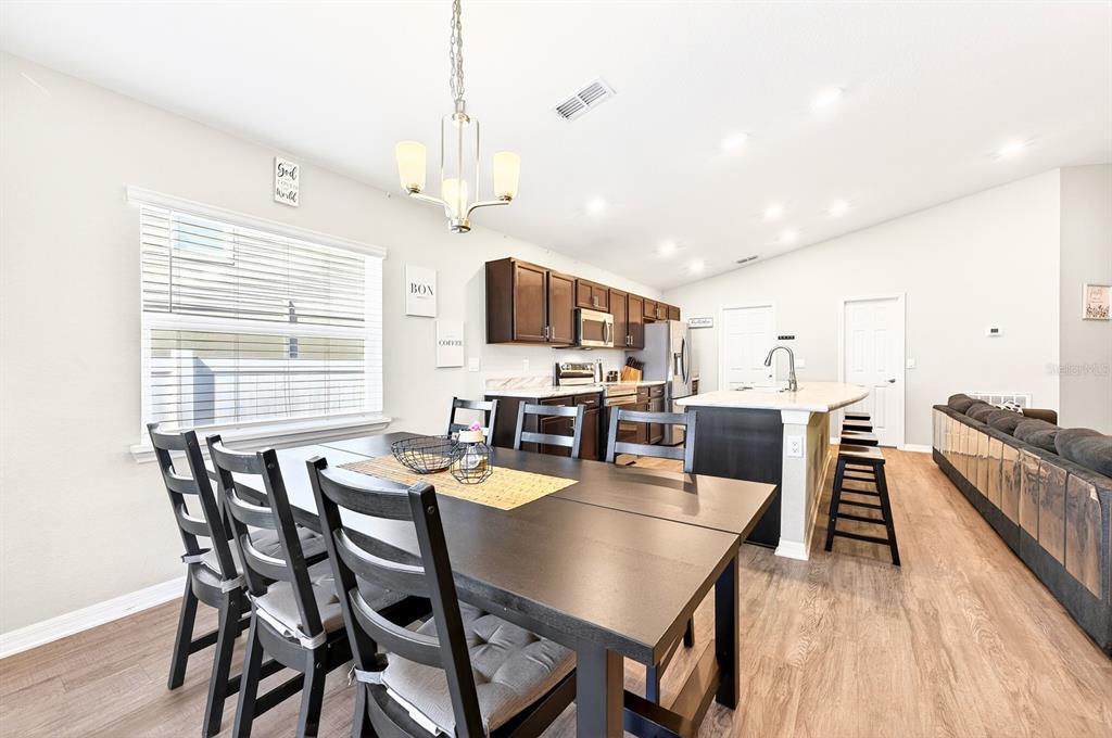 6348 Gardner Road Lakeland, FL 33813 - Photo 12 of 26 a view of a dining room with furniture window and wooden floor