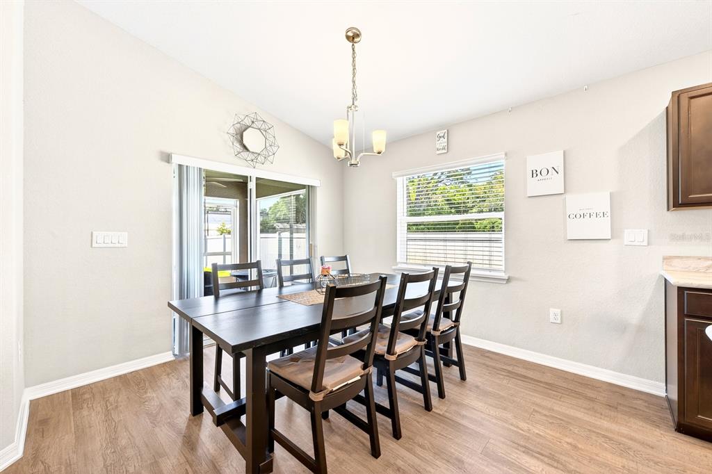 6348 Gardner Road Lakeland, FL 33813 - Photo 13 of 26 a view of a dining room with furniture window and wooden floor