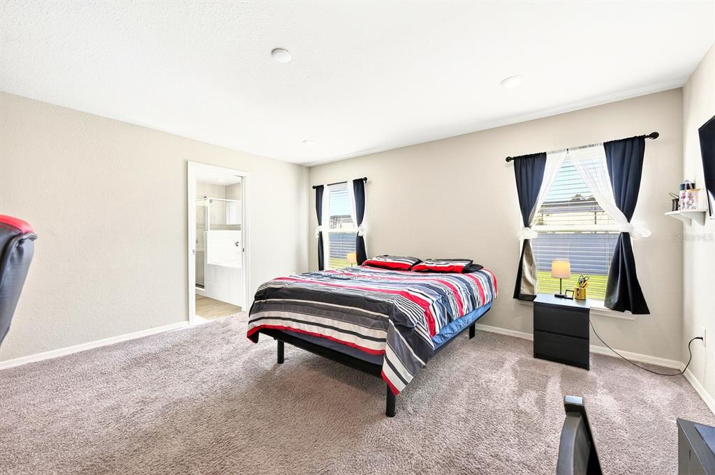 6348 Gardner Road Lakeland, FL 33813 - Photo 14 of 26 a bedroom with a bed and window