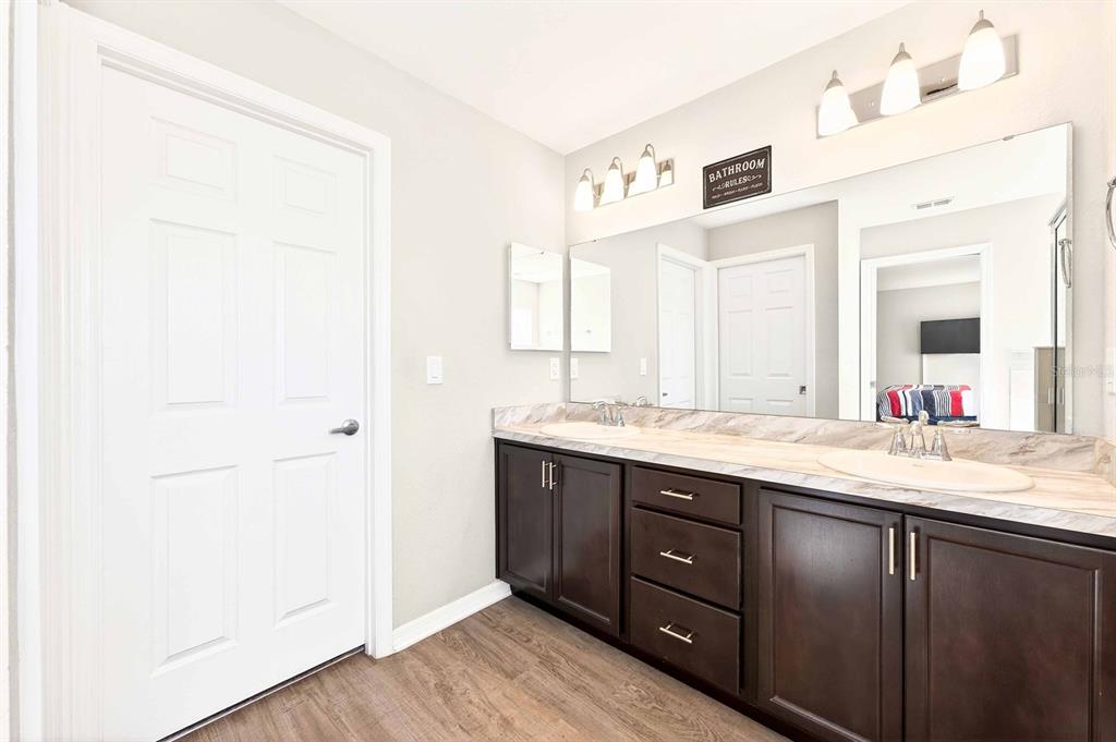 6348 Gardner Road Lakeland, FL 33813 - Photo 16 of 26 a spacious bathroom with a granite countertop sink and a mirror