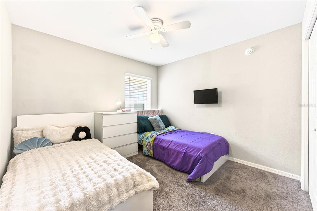 6348 Gardner Road Lakeland, FL 33813 - Photo 19 of 26 a bedroom with two bed and a flat screen tv