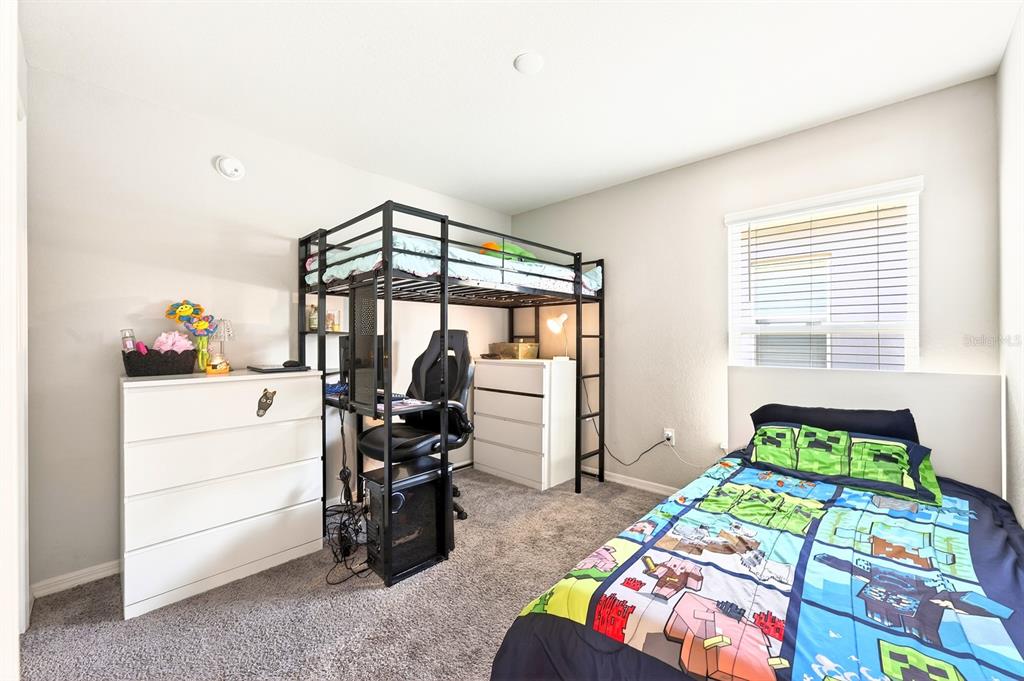 6348 Gardner Road Lakeland, FL 33813 - Photo 21 of 26 a bedroom with a bed and a window