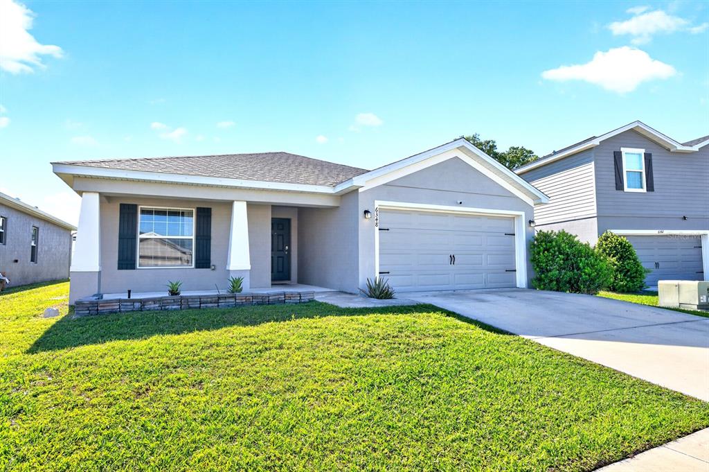 6348 Gardner Road Lakeland, FL 33813 - Photo 26 of 26 a front view of a house with a yard and porch