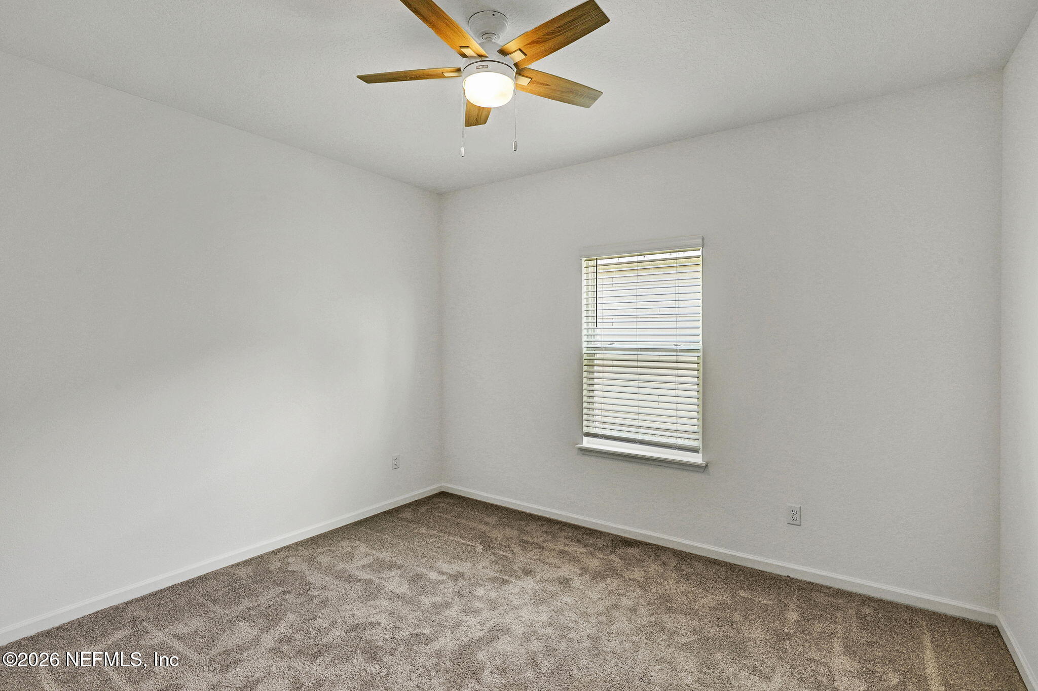 89 Kingsley Pk Way St. Augustine, FL 32084 - Photo 12 of 29 an empty room with a window and a fan