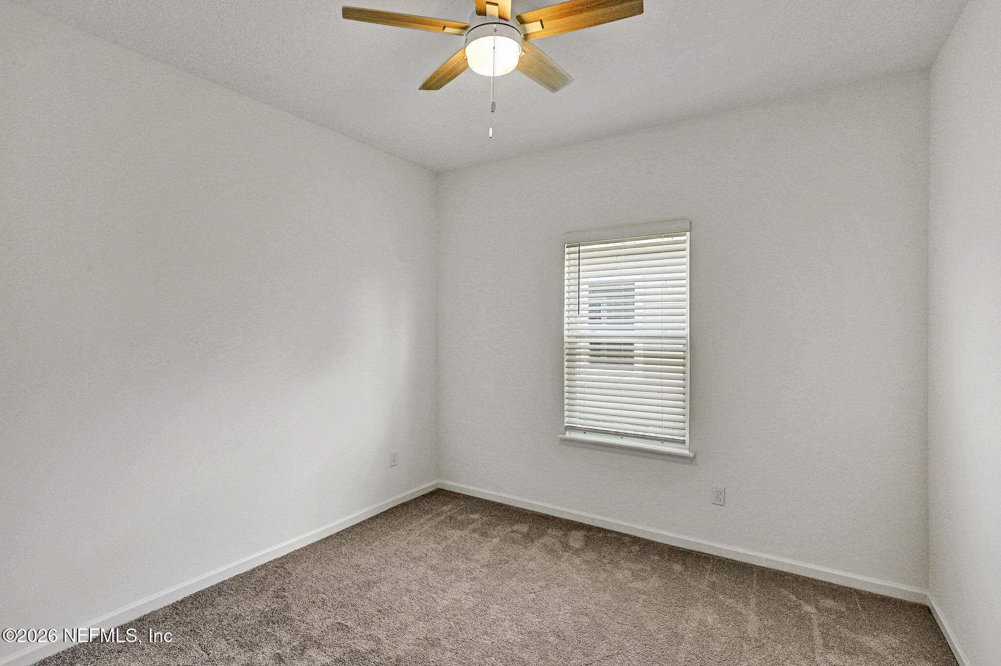 89 Kingsley Pk Way St. Augustine, FL 32084 - Photo 15 of 29 an empty room with a window and a fan