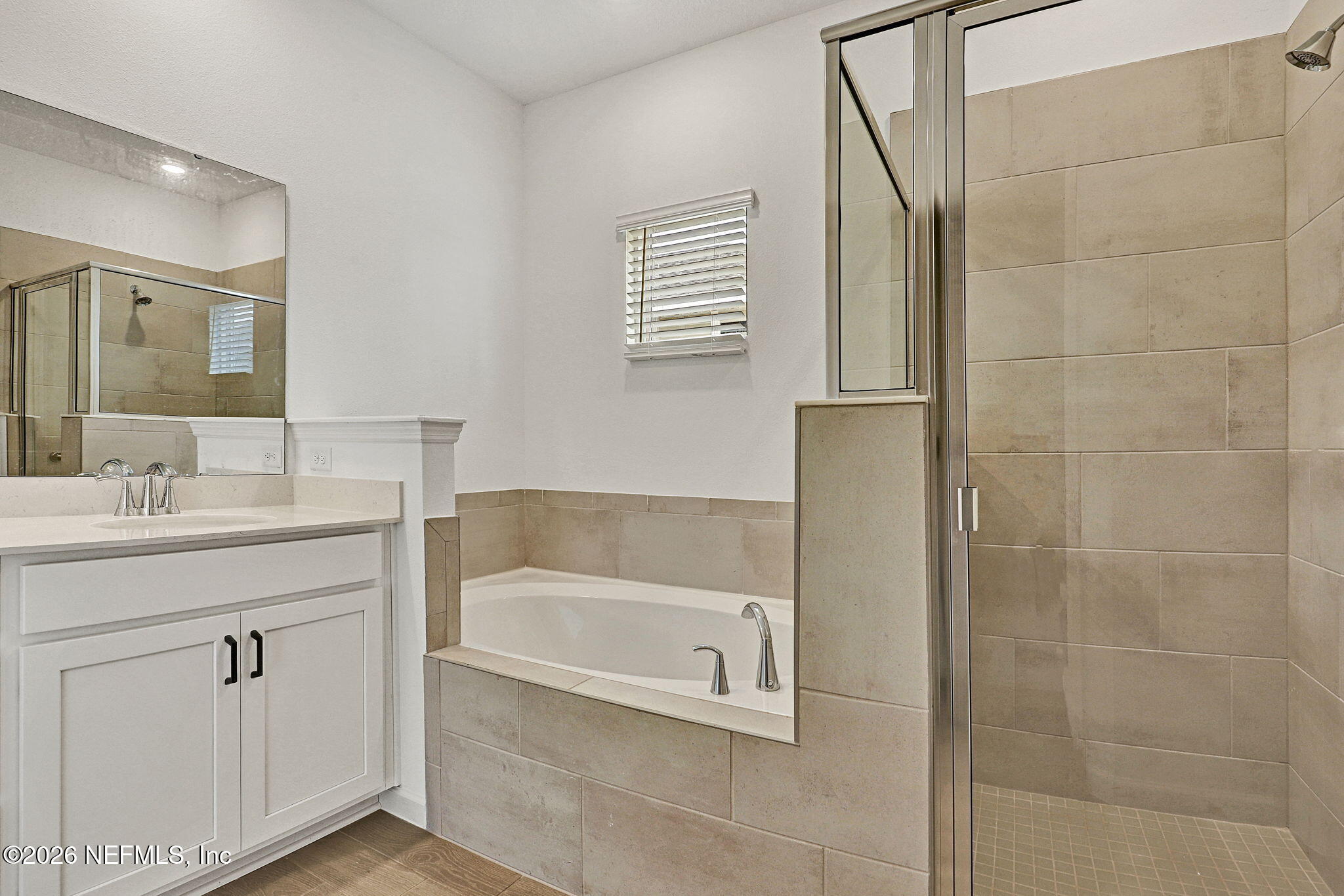 89 Kingsley Pk Way St. Augustine, FL 32084 - Photo 20 of 29 a bathroom with a bathtub a sink a vanity and a shower