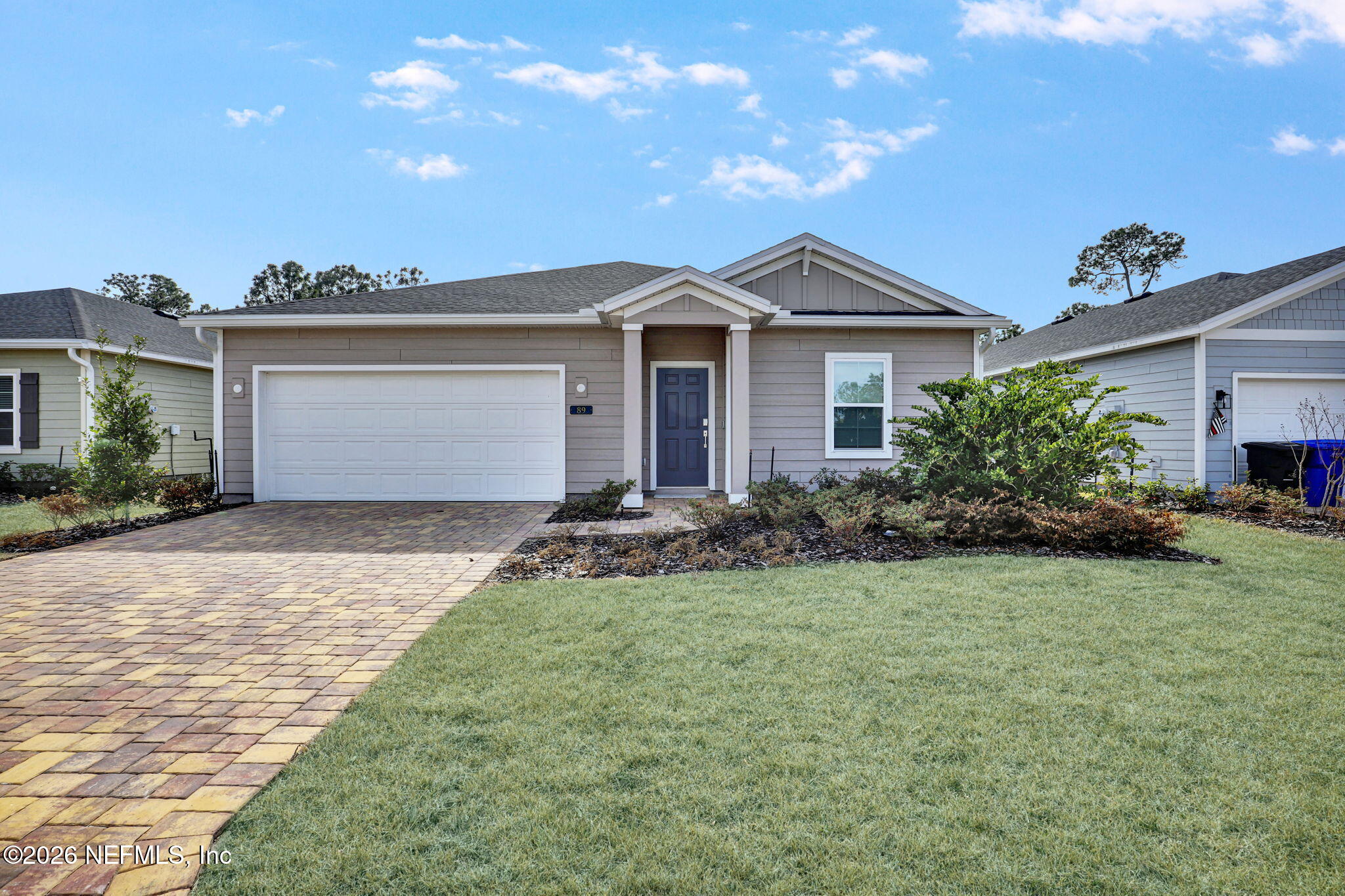 89 Kingsley Pk Way St. Augustine, FL 32084 - Photo 4 of 29 a front view of a house with a yard and garage