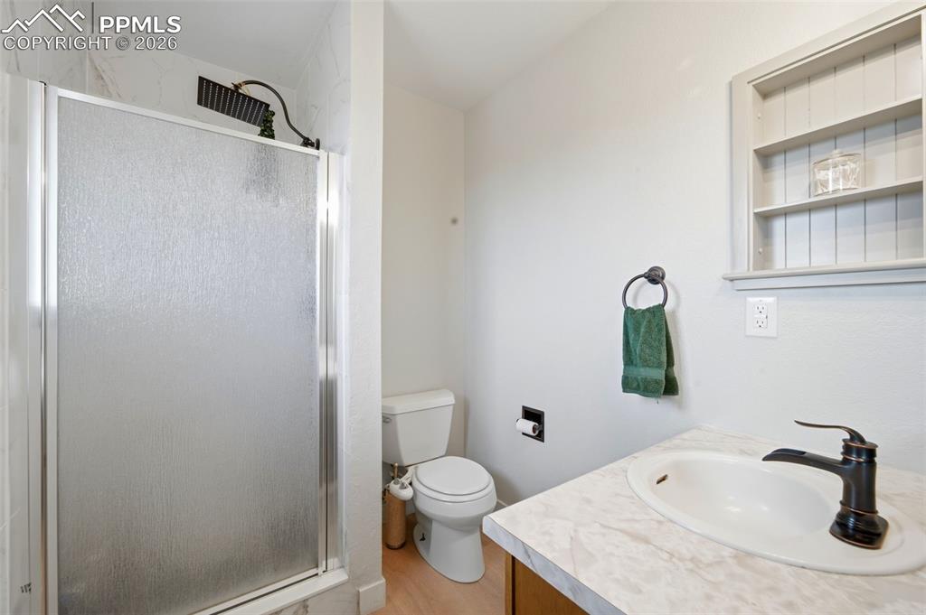 13815 Woodlake Road Elbert, CO 80106 - Photo 17 of 37 a bathroom with a sink toilet and shower