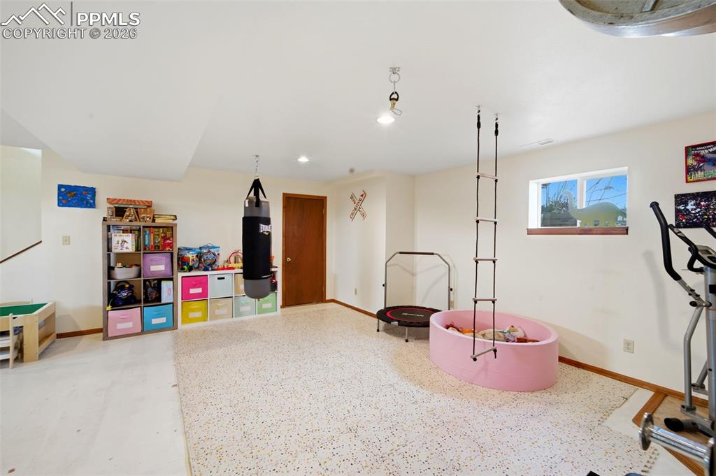 13815 Woodlake Road Elbert, CO 80106 - Photo 22 of 37 a bedroom with furniture and a flat screen tv