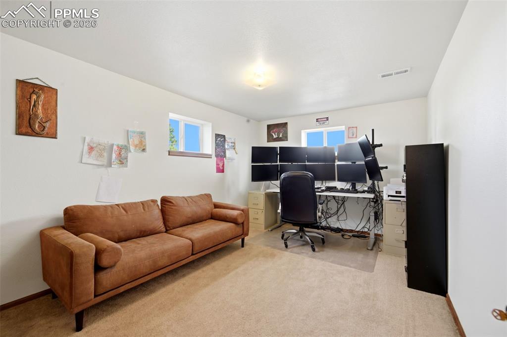 13815 Woodlake Road Elbert, CO 80106 - Photo 23 of 37 a work room with furniture and a couch