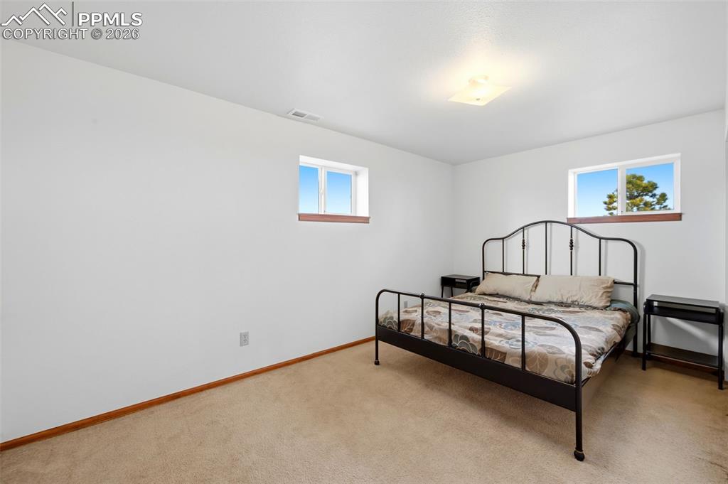 13815 Woodlake Road Elbert, CO 80106 - Photo 25 of 37 a bedroom with a bed and a window
